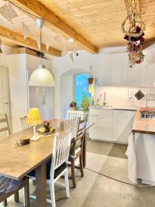 a kitchen and dining room with a wooden table and chairs at Bohemian accommodation in a magical idyll! in Simrishamn