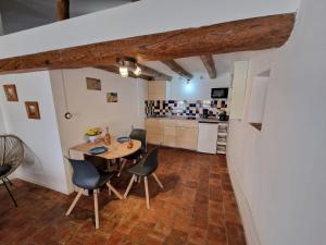 a kitchen and dining room with a table and chairs at Spacious attic apartment in Perelló