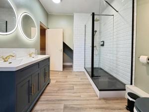a bathroom with a sink and a shower at The Roman Bath in York