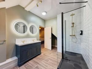 a bathroom with a sink and a shower at The Roman Bath in York