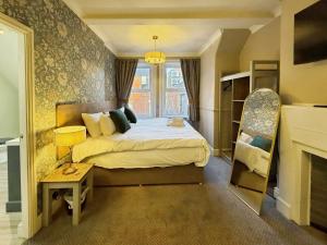 a hotel room with a bed and a fireplace at The Roman Bath in York