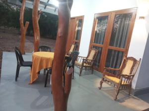 a table and chairs on the porch of a house at Villu Trails Wilpattu in Wilpattu +78 photos