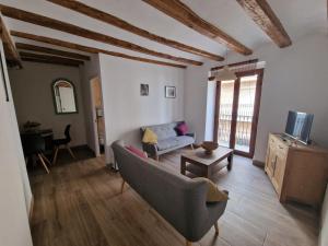 a living room with a couch and a tv at Centrally located two bedroom apartment in Perelló
