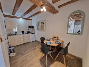 a kitchen and dining room with a table and chairs at Centrally located two bedroom apartment in Perelló
