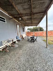 a patio with a ping pong table and benches at Mirante Itajubá in Barra Velha