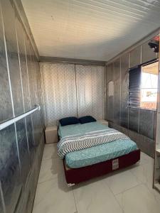 a small bedroom with two beds in it at Mirante Itajubá in Barra Velha