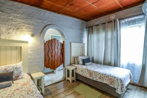 a bedroom with two beds and a large window at Flamboyant Guesthouse in Bela-Bela +87 photos