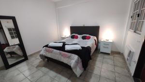 a bedroom with a bed and a mirror in it at Departamento La Merced in Santiago del Estero