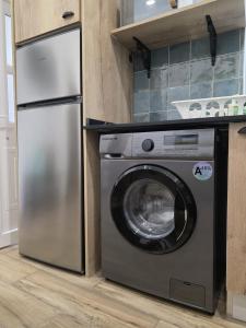 a refrigerator and a washing machine in a kitchen at Casinhas da Ajuda nº13 in Lisbon