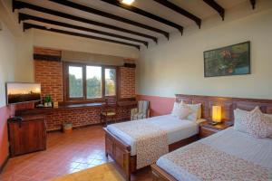 a bedroom with two beds and a flat screen tv at Traditional Comfort Boutique Hotel in Kathmandu