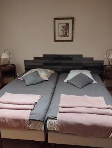 a bed with two pillows on it in a bedroom at Le Kalblin in Fréland