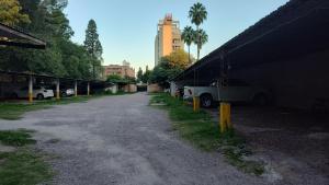a street with cars parked next to a building at Departamento La Merced in Santiago del Estero