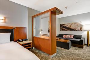 a hotel room with a bed and a couch at SpringHill Suites Denver at Anschutz Medical Campus in Aurora