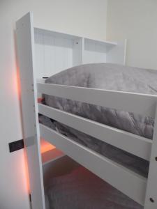 a white bunk bed in a small room at Casa Marta - tra vigne e motori in Castelvetro di Modena