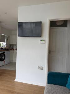 a living room with a door and a kitchen at Sixty Four - with 2 free car parking spaces in The Mumbles