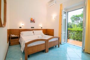a bedroom with a bed and a large window at Hotel Pineta in Ischia Town +58 photos