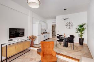 a living room with a table and a dining room at VERSA by Apiro Syros in Ermoupoli