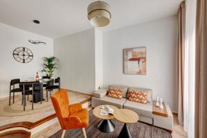 a living room with a couch and a table at VERSA by Apiro Syros in Ermoupoli