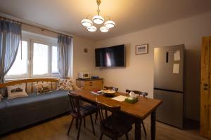 a room with a table and a bed and a kitchen at U Čertovy brázdy in Sázava +32 photos