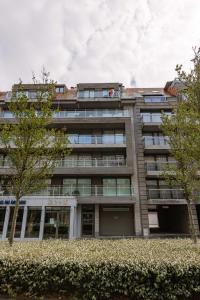 an apartment building with a man on the top of it at Casiola - Spacious & light apartment with double terrace in Nieuwpoort +21 photos