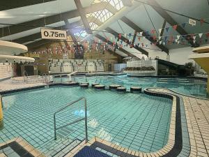 a large swimming pool in a large building at Valley Lodge 3 in Callington