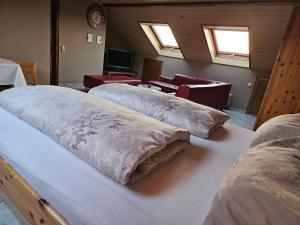 a room with three beds with pillows on them at Lieblingsplatz in Ebersburg