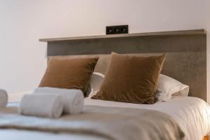 a bed with two pillows and two towels on it at Casiola - Nice apartment close to the beach with parking in Nieuwpoort