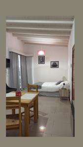 a living room with a bed and a table in a room at Monoambiente centrico-Paseo Plaza in Navarro