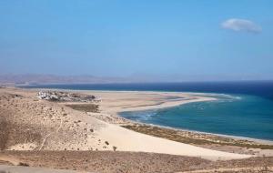 an aerial view of a beach and the ocean at Las Arenas in Costa Calma +1 photo