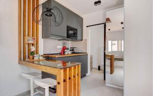 a kitchen with a sink and a counter with stools at Las Arenas in Costa Calma