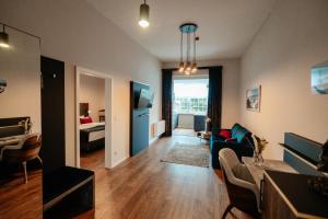 a living room with a couch and a table at Residence Black Eagle Lubmin Strand in Lubmin