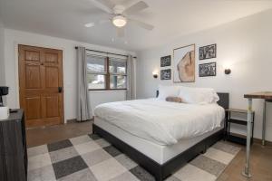 a bedroom with a bed and a ceiling fan at Lumber Jill Lodge in Balsam Lake