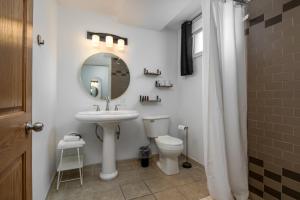 a bathroom with a sink and a toilet and a mirror at Lumber Jill Lodge in Balsam Lake +30 photos