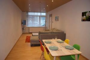 a living room with a table and a couch at Cozy Apartment for 4 Steps from the Beach in Ostend