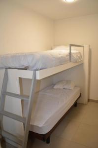 a bedroom with two bunk beds in a room at Cozy Apartment for 4 Steps from the Beach in Ostend +5 photos
