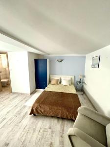 a bedroom with a large bed and a couch at Pokoje w Kołobrzegu in Kołobrzeg