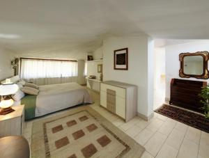 a bedroom with a bed and a mirror on the wall at Casa di Rita in Morlupo