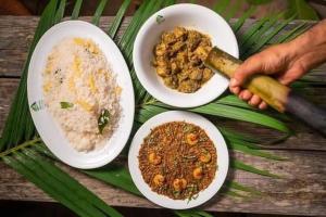 a table with three plates of food on it at Green Peak Resorts in Baitarāni +21 photos