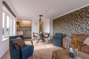a living room with a couch and a table at Casiola - Cosy apartment with vintage interior in De Haan