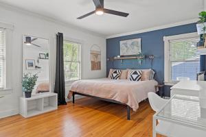 a bedroom with a bed and a blue wall at Entertainer - Brookside Walkable Firepit in Kansas City