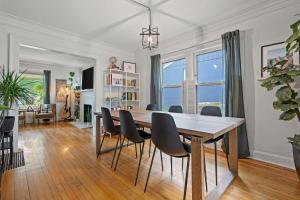 a dining room and living room with a table and chairs at Entertainer - Brookside Walkable Firepit in Kansas City