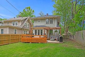 a house with a wooden fence in the yard at Entertainer - Brookside Walkable Firepit in Kansas City