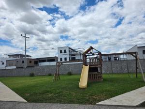 a playground with a swing set in a yard at Luana's 0601 in Choluteca
