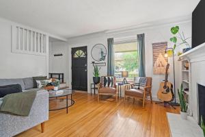 a living room with a couch and a table at Entertainer - Brookside Walkable Firepit in Kansas City