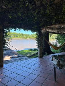 a patio with a hammock and a view of a river at Isla Casinha Delta Tigre in Tigre