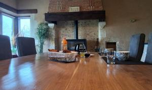 a wooden table with a basket of food on it at Bed and Breakfast au calme in Avoise