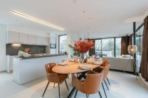 a kitchen and dining room with a table and chairs at Casiola - Apartment with two large terraces in Zedelgem +17 photos