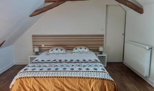 a bedroom with a large bed with a wooden headboard at Bed and Breakfast au calme in Avoise +8 photos