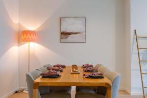 a dining room table with chairs and a tableablish at Casiola - Luminous family apartment with magnificent view in Ostend