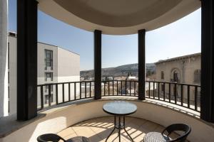 a balcony with a table and chairs on a building at Hotel Astoria Tbilisi in Tbilisi City
